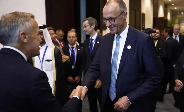 German Chancellor Freidrich Merz meets meets Canadian Prime Minister Mark Carney, left, at the Gaza International Peace Summit, in Sharm el-Sheikh, Egypt, Monday, Oct.13 2025. (Yoan Valat, Pool photo via AP)