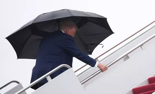 President Donald Trump boards Air Force One, Sunday, Oct. 12, 2025, at Joint Base Andrews, Md.., as he heads to the Middle East. (AP Photo/Evan Vucci)