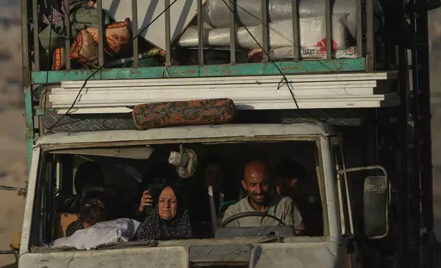 Displaced Palestinians flee northern Gaza carrying their belongings along the coastal road near Wadi Gaza, Thursday, Oct. 2, 2025. (AP Photo/Abdel Kareem Hana)