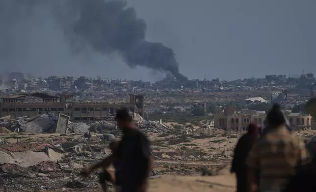 Smoke rises to the sky following an Israeli military strike in Gaza City, as seen from the central Gaza Strip, Thursday, Oct. 2, 2025. (AP Photo/Abdel Kareem Hana)