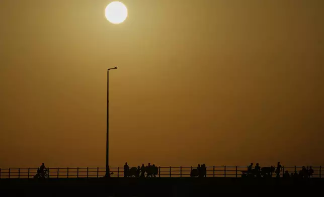 Displaced Palestinians flee northern Gaza carrying their belongings along the coastal road near Wadi Gaza, Thursday, Oct. 2, 2025. (AP Photo/Abdel Kareem Hana)