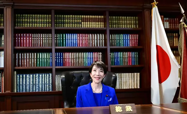 CORRECTS SITUATION - Sanae Takaichi, the newly-elected leader of Japan's ruling party, the Liberal Democratic Party (LDP), poses in the party leader's office after the LDP leadership election in Tokyo Saturday, Oct. 4, 2025. (Yuichi Yamazaki/Pool Photo via AP)