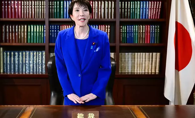 Sanae Takaichi, the newly-elected leader of Japan's ruling party, the Liberal Democratic Party (LDP), gestures as she leaves the party leader's office after the LDP leadership election in Tokyo Saturday, Oct. 4, 2025. (Yuichi Yamazaki/Pool Photo via AP)