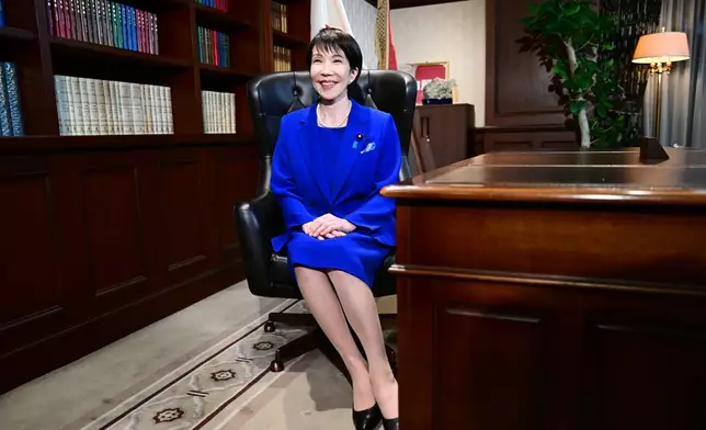 Sanae Takaichi, the newly-elected leader of Japan's ruling party, the Liberal Democratic Party (LDP), poses in the party leader's office after the LDP leadership election in Tokyo Saturday, Oct. 4, 2025. (Yuichi Yamazaki/Pool Photo via AP)