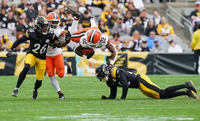 Cleveland Browns running back Dylan Sampson (22) is upended by Pittsburgh Steelers safety Juan Thornhill, right, on a kick off return after a field goal in the first half of an NFL football game in Pittsburgh, Sunday, Oct. 12, 2025. (AP Photo/Matt Freed)