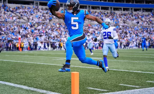 Carolina Panthers running back Rico Dowdle (5) runs the ball for a touchdown in the second half of an NFL football game against the Dallas Cowboys, Sunday, Oct. 12, 2025, in Charlotte, N.C. (AP Photo/Erik Verduzco)