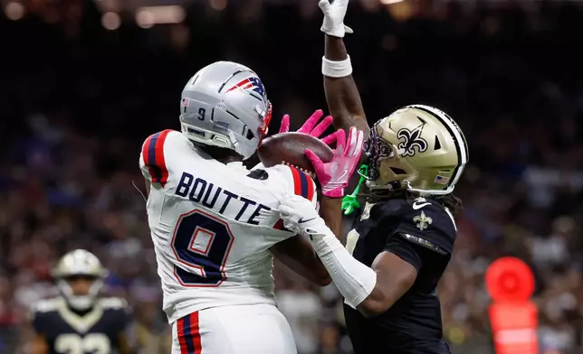 New England Patriots wide receiver Kayshon Boutte, left, catches a pass for a touchdown against New Orleans Saints cornerback Kool-Aid McKinstry during the first half of an NFL football game, Sunday, Oct. 12, 2025, in New Orleans. (AP Photo/Butch Dill)