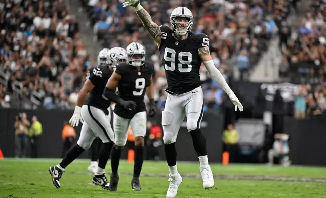 Las Vegas Raiders defensive end Maxx Crosby (98) celebrates after sacking Tennessee Titans quarterback Cam Ward during the first half of an NFL football game, Sunday, Oct. 12, 2025, in Las Vegas. (AP Photo/David Becker)