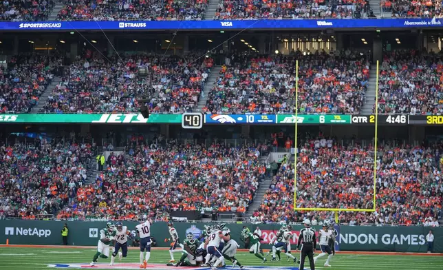 Denver Broncos quarterback Bo Nix (10) passes the ball in the first half of an NFL football game between the Denver Broncos and the New York Jets, Sunday, Oct. 12, 2025, in London. (AP Photo/Kin Cheung)