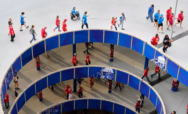 Fans walk up a ramp leading to a seating area inside Arrowhead Stadium before an NFL football game between the Kansas City Chiefs and the Detroit Lions Sunday, Oct. 12, 2025, in Kansas City, Mo. (AP Photo/Charlie Riedel)