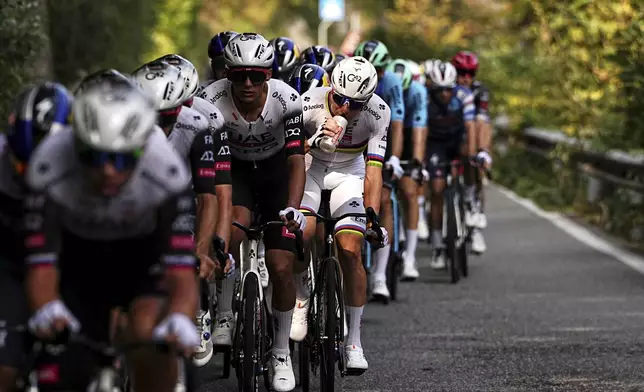 Slovenia's Tadej Pogacar, center, pedals during Il Lombardia, Tour of Lombardy cycling race, in Como, Italy, Saturday, Oct. 11, 2025. (Marco Alpozzi/LaPresse via AP)