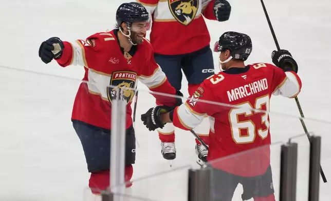 Florida Panthers left wing Brad Marchand (63) celebrates his goal with center Luke Kunin (71) during the third period of an NHL hockey game against the Philadelphia Flyers, Thursday, Oct. 9, 2025, in Sunrise, Fla. (AP Photo/Marta Lavandier)
