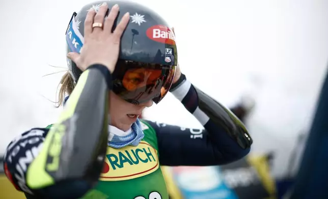 United States' Mikaela Shiffrin puts on her helmet at the starting gate of an alpine ski, women's World Cup giant slalom, in Soelden, Austria, Saturday, Oct. 25, 2025. (AP Photo/Gabriele Facciotti)
