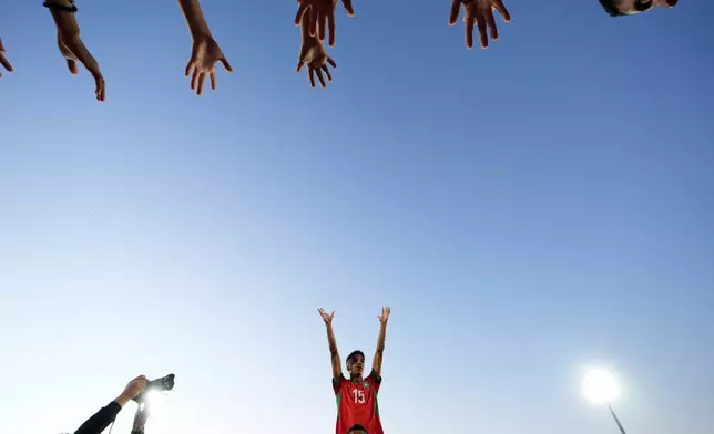 Morocco's Fouad Zahouani celebrates with fans after defeating France in a penalty shootout during a FIFA U-20 World Cup semifinal soccer match at Elias Figueroa Brander Stadium in Valparaiso, Chile, Wednesday, Oct. 15, 2025.(AP Photo/Matias Delacroix)