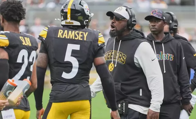 Pittsburgh Steelers head coach Mike Tomlin, right, talks with cornerback Jalen Ramsey (5) in the first half of an NFL football game against the Cleveland Browns in Pittsburgh, Sunday, Oct. 12, 2025. (AP Photo/Gene J. Puskar)
