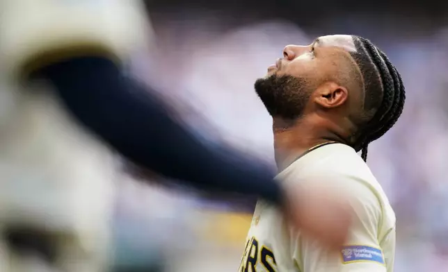 Milwaukee Brewers' Jackson Chourio (11) reacts to leaving the game with an injury during the second inning in Game 1 of baseball's National League Division Series game against the Chicago Cubs on Saturday, Oct. 4, 2025, in Milwaukee. (AP Photo/Kayla Wolf)
