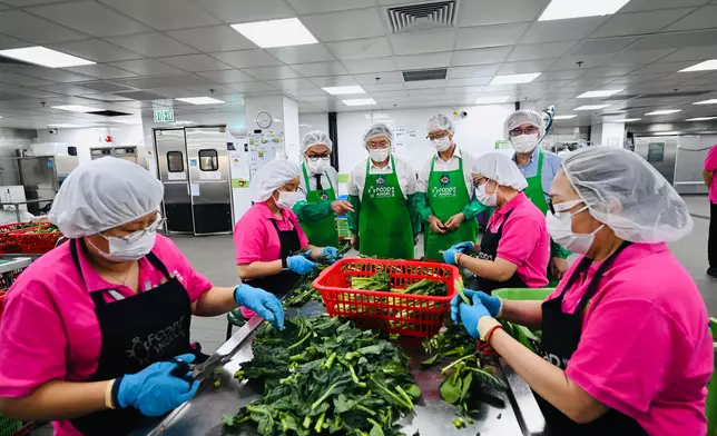 Guests tour the Food Angel Jockey Club Food Production Centre.