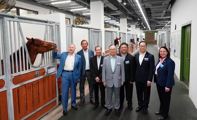 Guests including Fletch Chan, Permanent Secretary for Labour and Welfare (Acting) (3rd right); The Hon Martin Liao, Chairman of The Hong Kong Jockey Club and the Hong Kong Jockey Club Public Riding School Limited (middle); Dr Simon Ip, Club Public Riding Schools Limited Independent Non-executive Director (2nd left); Thomas Yeung, Chairman of the Riding for the Disabled Association (2nd right); Professor Frederick Ho, Chairman of the Hong Kong PHAB Association (3rd left); and Amanda Bond, Head of Equestrian Affairs of The Hong Kong Jockey Club (1st right) tour the HKJC Pokfulam Public Riding School.