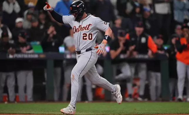 Detroit Tigers' Spencer Torkelson runs home to score the go-ahead run off of a single hit by Zach McKinstry during the 11th inning in Game 1 of baseball's American League Division Series against the Seattle Mariners, Saturday, Oct. 4, 2025, in Seattle. (AP Photo/Lindsey Wasson)