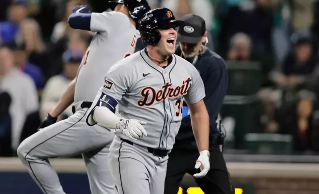 Detroit Tigers' Kerry Carpenter reacts after hitting a two-run home run during the fifth inning in Game 1 of baseball's American League Division Series against the Seattle Mariners, Saturday, Oct. 4, 2025, in Seattle. (AP Photo/John Froschauer)