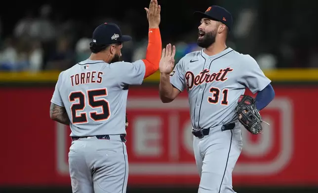 Detroit Tigers left fielder Riley Greene, right, and second baseman Gleyber Torres celebrate after the team's win in Game 1 of baseball's American League Division Series against the Seattle Mariners, Saturday, Oct. 4, 2025, in Seattle. (AP Photo/Lindsey Wasson)