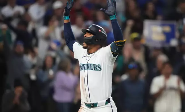Seattle Mariners' Julio Rodriguez celebrates after hitting a solo home run during the fourth inning in Game 1 of baseball's American League Division Series against the Detroit Tigers, Saturday, Oct. 4, 2025, in Seattle. (AP Photo/Lindsey Wasson)