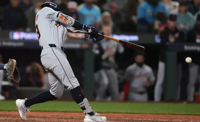 Detroit Tigers' Zach McKinstry hits a single to score Spencer Torkelson for the go-ahead run during the 11th inning in Game 1 of baseball's American League Division Series against the Seattle Mariners, Saturday, Oct. 4, 2025, in Seattle. (AP Photo/Lindsey Wasson)