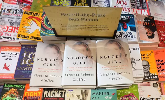 The memoir book of Virginia Giuffre, "Nobody's Girl" is seen amongst other books in a store and is up for sale in London, Tuesday, Oct. 21, 2025 six months after Giuffre died by suicide in April.(AP Photo/Kirsty Wigglesworth)