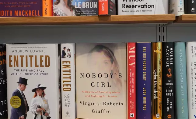 The memoir book of Virginia Giuffre, "Nobody's Girl" sits on a shelf amongst other books and is up for sale at a book store in London, Tuesday, Oct. 21, 2025 six months after Giuffre died by suicide in April.(AP Photo/Kirsty Wigglesworth)