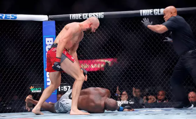 Jiri Prochazka, top left, of Czechia, knocks out Khalil Rountree Jr., bottom, of the United States, in a light heavyweight bout during UFC 320, Saturday, Oct. 4, 2025, in Las Vegas. (Steve Marcus/Las Vegas Sun via AP)