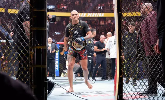 Alex Pereira, of Brazil, leaves the Octagon after defeating UFC light heavyweight champion Magomed Ankalaev, of Russia, during UFC 320 Saturday, Oct. 4, 2025, in Las Vegas. (Steve Marcus/Las Vegas Sun via AP)