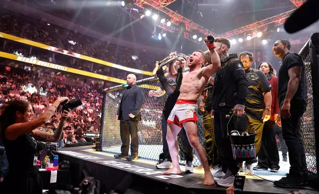 UFC bantamweight champion Merab Dvalishvili, of Georgia, celebrates after defeating Cory James Sandhagen, of the United States, during UFC 320 Saturday, Oct. 4, 2025, in Las Vegas. (Steve Marcus/Las Vegas Sun via AP)