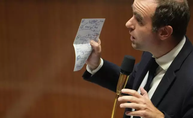 French Prime Minister Sebastien Lecornu answers lawmakers after his policy speech at the National Assembly, Tuesday, Oct. 14, 2025 in Paris. (AP Photo/Thibault Camus)