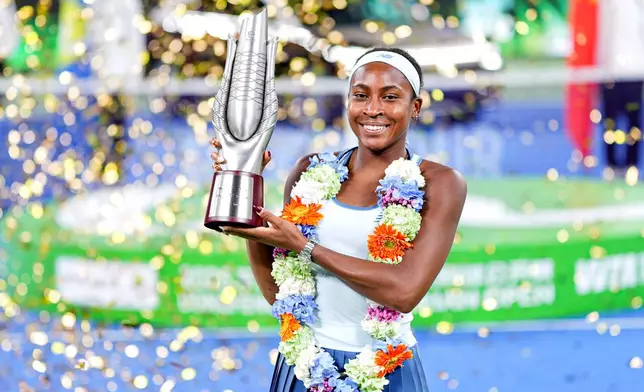 Coco Gauff of the United States celebrates with her trophy after defeating her compatriot Jessica Pegula in the women's singles final at the WTA Wuhan Open in Wuhan in central China's Hubei province Sunday, Oct. 12, 2025. (Chinatopix Via AP) CHINA OUT