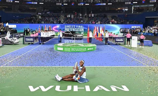 Coco Gauff of the United States celebrates with her trophy after defeating her compatriot Jessica Pegula in the women's singles final at the WTA Wuhan Open in Wuhan in central China's Hubei province Sunday, Oct. 12, 2025. (Chinatopix Via AP) CHINA OUT
