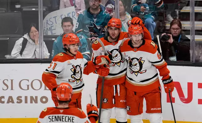 Anaheim Ducks left wing Cutter Gauthier (61) celebrates with teammates after scoring a goal during the third period of an NHL hockey game against the San Jose Sharks, Saturday, Oct. 11, 2025, in San Jose, Calif. (AP Photo/Godofredo A. Vásquez)