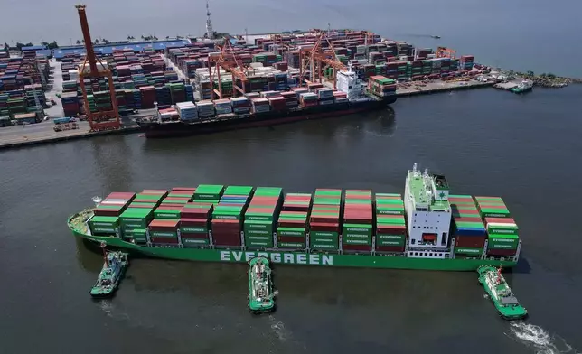 FILE - Tugboats assist a container ship as it prepares to dock at the Manila International Container Terminal at the Philippine capital April 8, 2025. (AP Photo/Aaron Favila, File)