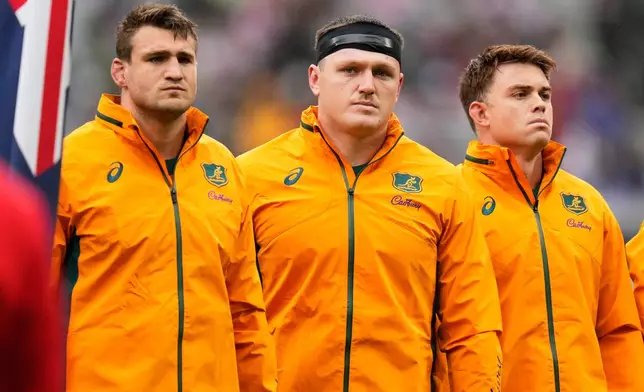 Australia's captain Nick Champion de Crespigny, left, stands with teammates Angus Bell and Andrew Kellaway, right, ahead of the rugby test between the Wallabies and Japan in Tokyo, Saturday, Oct. 25, 2025. (AP Photo/Shuji Kajiyama)