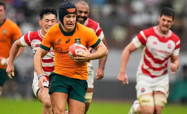 Australia's Josh Flook runs to scores a try during a rugby test between the Wallabies and Japan in Tokyo, Saturday, Oct. 25, 2025. (AP Photo/Shuji Kajiyama)
