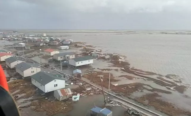 In this photo provided by the U.S. Coast Guard, Kipnuk, Alaska, experiences coastal flooding, Sunday, Oct. 12, 2025. (U.S. Coast Guard via AP)