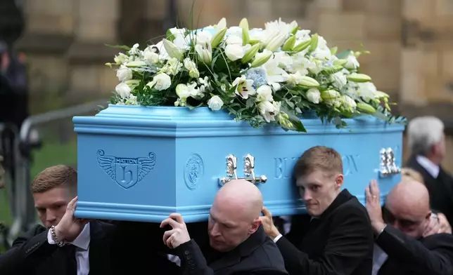 Family members carry the coffin of boxer Ricky Hatton out of Manchester Cathedral following his funeral in Manchester, England, Friday, Oct. 10, 2025. (AP Photo/Jon Super)