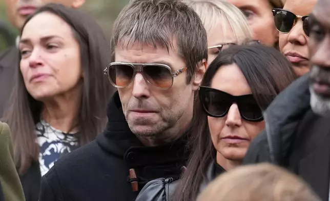 Liam Gallagher, center, of the band Oasis attends the funeral for boxer Ricky Hatton in Manchester, England, Friday, Oct. 10, 2025. (AP Photo/Jon Super)