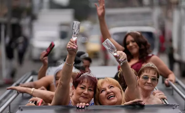 Blanca Guerrero, 67, left, and Gloria Sanabria, 67, right, ride in a limousine to a quinceanera celebration for women who never had a traditional 15th birthday party, organized by the Suenos Hechos foundation in Bogota, Colombia, Friday, Oct. 24, 2025.(AP Photo/Fernando Vergara)