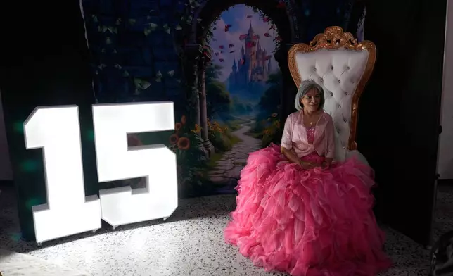 Carmen Mora, 71, poses for a photo during a quinceanera celebration for women who never had a 15th birthday party, organized by the Suenos Hechos foundation in Bogota, Colombia, Friday, Oct. 24, 2025. (AP Photo/Fernando Vergara)