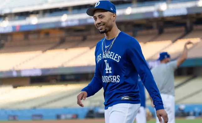 Los Angeles Dodgers' Mookie Betts walks across the field during practice Tuesday, Oct. 7, 2025, in Los Angeles, the day before Game 3 of baseball's National League Division Series against the Philadelphia Phillies. (AP Photo/Jae C. Hong)