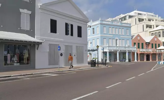 A man walks down a street with closed businesses ahead of Hurricane Imelda's expected arrival in Hamilton, Bermuda, Wednesday, Oct. 1, 2025. (AP Photo/Anthony Wade)