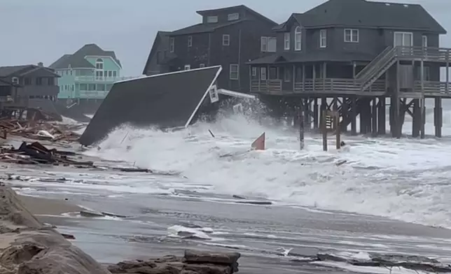 Waves from Hurricanes Humberto and Imelda destroy a home in Buxton, N.C., Tuesday, Sept. 30, 2025. (Heather Jennette via AP)