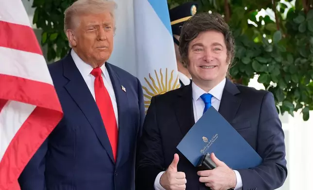 President Donald Trump greets Argentina's President Javier Milei at the White House, Tuesday, Oct. 14, 2025, in Washington. (AP Photo/Alex Brandon)
