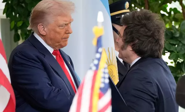 President Donald Trump greets Argentina's President Javier Milei at the White House, Tuesday, Oct. 14, 2025, in Washington. (AP Photo/Alex Brandon)