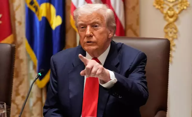 President Donald Trump speaks during a meeting with Argentina's President Javier Milei in the Cabinet Room of the White House, Tuesday, Oct. 14, 2025, in Washington. (AP Photo/Alex Brandon)